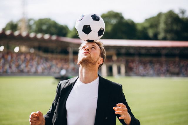 images/handsome-football-player-stadium-business-suit.jpg